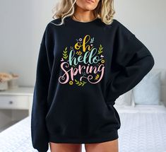 "Oh Hello Spring Sweatshirt, Spring Sweatshirt, Cute Spring Sweatshirt, Welcome Spring Short, Spring Season Sweatshirt, Cute T-shirt Hi! Welcome to✨Northstar ✨ ✨As the weather gets colder, you want clothes that keep you and your body warm. Here, Northstar  is ready to keep you warm with its unique designs..✨ ✨Product Features✨ 👉Medium-heavy fabric (8.0 oz/yd² (271.25 g/m 👉Loose fit 👉Runs true to size 👉50% cotton, 50% polyester 👉Tear-away label ✨Care Instructions✨ 👉Wash item inside out in c Spring Cotton Sweatshirt With Lettering, Spring Lettering Sweatshirt Relaxed Fit, Relaxed Fit Lettering Sweatshirt For Spring, Relaxed Fit Sweatshirt With Lettering For Spring, Spring Long Sleeve Tops With Lettering, Spring Letter Print Sweatshirt, Spring Graphic Tee Sweatshirt With Letter Print, Spring Sweatshirt, Spring Shorts