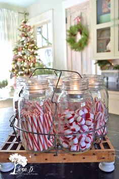 mason jars filled with candy canes on a tray