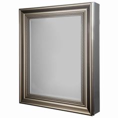 a silver framed mirror on a white wall