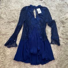 Navy Free People Lace Dress. You Will Have To Wear Something Underneath. It Is Flowing. Long Sleeve Navy. Size Medium. Also Never Been Worn. Blue Mini Dress With Lace Patchwork, Blue Lace Patchwork Mini Dress For Spring, Blue Long Sleeve Mini Dress With Lace Trim, Long Sleeve Blue Mini Dress With Lace Trim, Blue Lace Patchwork Dress For Beach, Blue Lace Trim Dress For Fall, Blue Bohemian Mini Dress With Lace Trim, Blue Chic Dress With Lace Patchwork, Bohemian Blue Mini Dress With Lace Trim