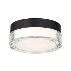 a black and white ceiling light with a circular glass shade on the top of it