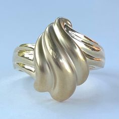 "Gorgeous 14k solid yellow gold abstract wavy flame ring! This ring is approximately a size 6. It measures approximately 5/8\" tall at the head. The \"flame\" portion of the ring is beautiful matte gold textured and is set against a highly polished band. The inside of the band is stamped for \"VELLMAR 14K\". This ring will arrive in gift packaging and secure domestic shipping is included at no additional charge. International and upgraded shipping is available at checkout. Please see pictures, a Elegant Swirl Shaped Metal Jewelry, Elegant Wavy Jewelry With Polished Finish, Unique Swirl Shaped Metal Jewelry, Unique Swirl-shaped Gold Jewelry, Gold Swirl-shaped Handmade Jewelry, Detailed Ring, Gold Texture, Matte Gold, Rings Statement