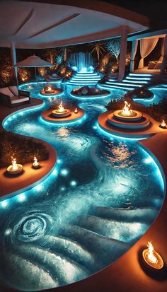 an indoor swimming pool with candles lit up in the water and steps leading down to it