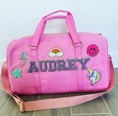 "High Quality Duffel Bag with your own Personal Touch! Nylon Waterproof Gold Hardware Bag is approx. 10\" tall x 18\" wide x 8\" deep Polyester lining inside. **ALL Patches are applied with Industrial Strength Adhesive, AND SEWN ON for lasting durability Choose any Color and Patch Combination! Color Options Include:  Baby Pink, Hot Pink, Salmon, Mint, Violet, Baby Blue, Cream, Black Patch Options Include: Heart, Smiley Face, Rainbow, Palm Tree, Anchor, Lightning Bolt, Stars, Minnie Mouse Bow, Mi Pink Satchel Travel Bag For School, Pink Rectangular Duffle Bag For School, Customizable Travel Pouch Bag, Pink Duffle Shoulder Bag For School, Pink Shoulder Duffle Bag For School, Customizable Pink Bags For Personal Use, Bag With Patches, Heart Smiley Face, Heart Smiley