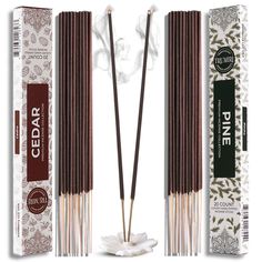 two incense sticks in front of an empty box and one stick with the word cedar on it