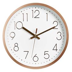 a white clock with brown hands and numbers on the face is shown against a white background