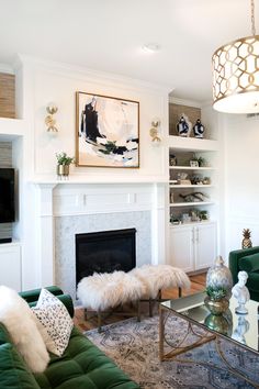 a living room filled with furniture and a fire place in front of a painting on the wall