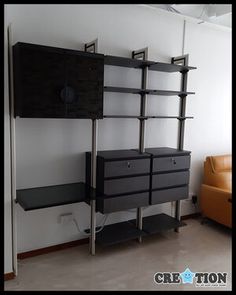 a living room with a couch and shelving unit