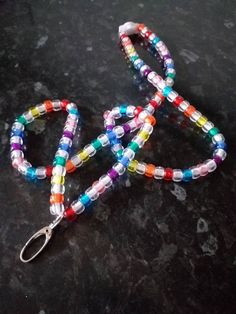 Handmade beaded multicoloured rainbow mix Lanyard Crafted using multicoloured pony beads, grosgrain ribbon and a silver metal swivel lobster clasp to attach ID badge holder/keyring/whistle etc.  Strong and robust design  Snap popper fastening at back of neck.  Also available with a breakaway clip if required. Total hanging length including clasp is 46cm/20 inches.  Can be made longer or shorter on request.  Please message me with the length you require and I will happily customise your lanyard for your needs 🙂 Any questions please message me 🙂 Multicolor Lanyards With Round Beads And Key Leash, Multicolor Beaded Lanyard With Key Leash, Multicolor Lanyards With Key Leash, Lanyard Crafts, Jewellery Gifts, Beaded Jewellery, Robust Design, Small Bottles, Id Badge Holders