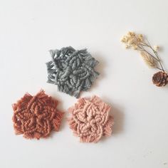 three pieces of crocheted fabric sitting next to each other on a white surface