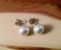 White color freshwater pearl studs .  10 mm , set on a sterling silver . Perfect gift for yourself , your best friend or  bridesmaids. Comes wrapped as  a gift  . colors may vary. The box in a picture is only for display. Any special request -  just write it to me in the "message to the seller" box of the order form. **LIMITED SUPPLY** All of our jewelry comes wrapped and ready for gift giving! To see more, please visit my shop at http://www.etsy.com/ca/shop/BadassjewelryToronto White Pearl Earrings, Pearl Bridal Jewelry, White Pearl Earring, Jewelry Christmas, Order Form, Bridal Pearls, Pearl Studs, Elegant Earrings, Bridesmaid Gift