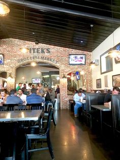 people are sitting at tables in a restaurant