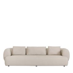 a white couch with four pillows on it