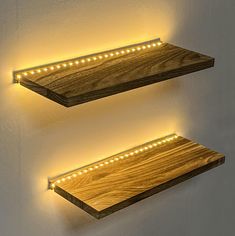 two wooden shelves with lights on them