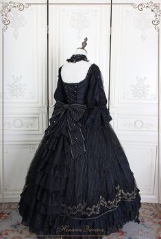 This Black Gothic Lolita Lace Wedding Dress With Corset Plus Size is a stunning alternative to a traditional white wedding dress. This dramatic and unique dress features a full-length black lace overlay with a corseted bodice and sweetheart neckline. The bodice is adorned with intricate silver embroidery, giving it a luxurious feel. The full-length skirt has a slight train and is finished off with a bow detail at the waist. The corset back allows for an adjustable fit to ensure you are comfortab Gothic Sweet 16 Dresses, Victorian Gothic Gown, Gothic White Wedding Dress, Gothic Ballgown, Goth Wedding Dress, Black Princess Dress, Gothic Corset Dresses, Vampire Lady, Goth Wedding Dresses