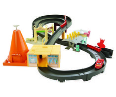 a toy train set with cars and traffic cones