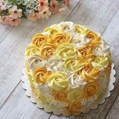 a cake decorated with yellow and white flowers