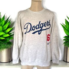 This vintage 1995 Dodgers Hideo Nomo #16 sweatshirt by Nutmeg Mills is in good condition. Featuring the Dodgers logo and "Nomo 16," it's a collectible piece from Nomo's iconic rookie season. Made in the USA, perfect for fans and collectors. Shoulder: 22"  Sleeve: 23" Body: 26"  Chest: 22" Throwback Fan Merchandise Cotton Sweatshirt, Throwback Cotton Sweatshirt For Fan Merchandise, Vintage Sweatshirt For Sports Season Fan Merchandise, Throwback Fan Merchandise Sweatshirt For Sports Season, Throwback Crew Neck Sweatshirt With Logo Print, Throwback Logo Print Sweatshirt For Sports Season, Throwback Sweatshirt With Logo Print For Sports Season, Throwback Crew Sweatshirt For Sports Season, Throwback Crew Neck Hoodie For Fan Merchandise