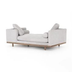 a white couch sitting on top of a wooden frame