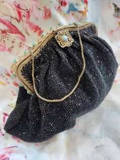 A truly beautiful, antique evening purse dating to the early 1900s. This is heavily beaded in tiny French Jet beads and lined in black silk. The filigree metal framework is decorated with tiny marcasite studs and satin glass cabochons. The clasp has a turquoise cabochon. The purse measures 20cm along the bottom, 12cm in height. The framework measures 14cm in length, 2cm in width. Condition wise, there are some areas of beadloss and marcasite studs, but is structurally sound. Despite that it is a Handmade Victorian Evening Bag, Antique Beaded Evening Bag, Antique Beaded Evening Bag For Party, Antique Beaded Evening Bag For Formal Events, Dress Clipart, Vintage Evening Bags, Glass Bangles, Dress Clip, 1930s Fashion