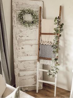 an old door is decorated with greenery and wreaths for the holiday decorating