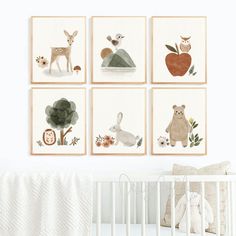 a baby's room with four framed pictures on the wall and a crib