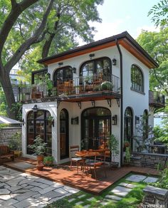 a white house with lots of windows and balconies on the second story balcony