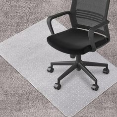 a black office chair sitting on top of a rug