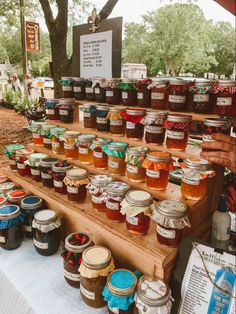 many jars of honey sit on a table