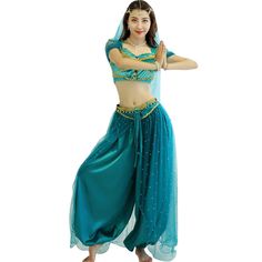 a woman in a blue belly dance outfit with her arms out to the side and one hand on her hip