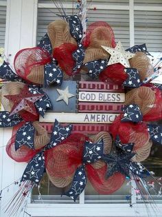 a patriotic wreath is hanging on the front door