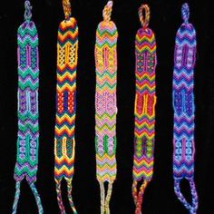 four crocheted items are lined up on a black background, one is multicolored