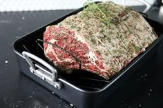 a large piece of meat in a black container