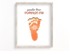 an orange handprint with the words perfect than pumpkin pie on it is hanging in a white frame