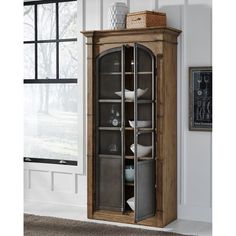 a tall wooden cabinet with glass doors and shelves