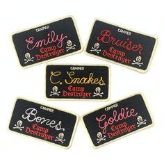 four embroidered patches with names on them