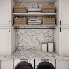 a washer and dryer in a room with marble counter tops on the wall