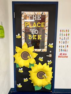 a classroom door decorated with sunflowers and the words, the place to be