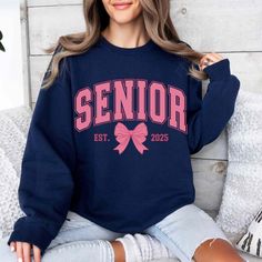 Senior 2025 Shirt, Coquette Senior Class Of 2025, Senior Pink Bow Sweatshirt, Senior 2025 Shirt, Graduation Gift, High School 🌟 Welcome to Our Shop! 🌟 Please Review All Photos Carefully for Details. 🌟 Select Your T-Shirt Size from the Dropdown Menu Next to the Product Image. 🌟 Choose Your T-Shirt Color from the Options Provided in the Second Picture. 🌟 Customize Your Order by Using the "Add Message to Seller" Link During Checkout. 🌟 Shipping Time Varies Depending on Your Location (We Operate from Sugar Land, Texas); Our Standard Processing Time is 1 to 3 Business Days. How to Place an Order: Review All Information Before Proceeding with Your Purchase. Choose Your Desired Shirt Type and Size from the Dropdown Menu. Select the Color of Your Shirt from the Options Available. For Additio Senior Tshirts 2025, Senior 2025 Shirts, Senior Shirts Ideas 2025, Senior Sweatshirts Ideas, Senior Tshirts, High School Senior Gifts, Senior Class Shirts, Senior Sweatshirts, Senior Year Fun