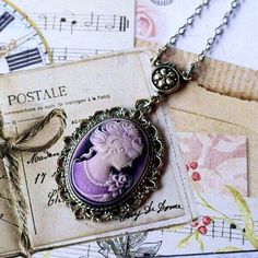 "Purple Cameo Necklace - Victorian Lady Cameo Necklace - Vintage Style Woman Cameo Pendant . . . . . Artisan handcrafted lovely Victorian style lady cameo necklace. This gorgeous vintage style purple young woman cameo is hand set in a ornate antique silver bezel. This reproduction cameo pendant suspends from a floral connector and delicate looking hypoallergenic quality soldered flat cable antique silver electroplated chain. Fastens with antique silverplated lobster claw. Purple Pearl drops from Ornate Cameo Necklace For Gift, Victorian Silver Cameo Jewelry, Victorian Purple, Gothic Cameo Necklace For Gift, Victorian Cameo Silver Necklace, Vintage Lavender, Ornate Cameo Necklace Collectible, Victorian Lady, Purple Pearl