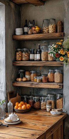 a wooden table topped with lots of shelves filled with jars and containers full of food