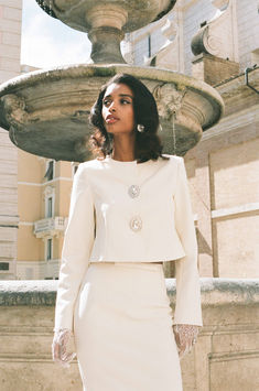 The Claira Coat embodies "simple elegance and refined retro" in its design, crafted from lustrous stretch suit fabric for a polished and sophisticated appearance. This cropped jacket sits just above the waistline, creating an elongating effect for the lower body and adding a sense of lightness. 

The Claira Skirt exudes "simple and refined" elegance, crafted from lustrous stretch suit fabric for a crisp, flattering fit and comfortable wear. White Skirt Suit, Bow Coat, Simple Elegance, Lower Body