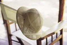 a hat sitting on top of a wooden chair