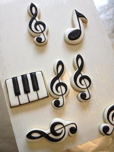 decorated cookies with music notes and piano keys on top of a sheet of white paper