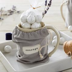 a mug filled with cotton balls on top of a tray