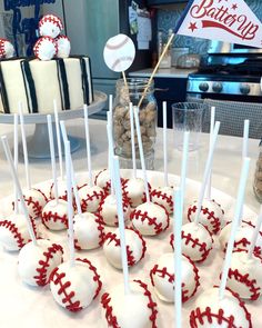 baseball cake pops are arranged on a plate