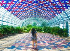 a woman is standing in the middle of a walkway with red, white and blue decorations