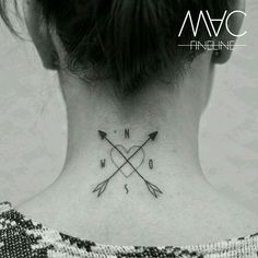 a woman's back neck with an arrow and heart tattoo on her left side