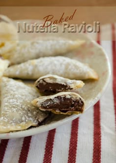 an assortment of pastries on a plate with banana slices and powdered sugar in the middle