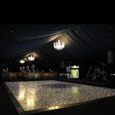 the dance floor is lit up and ready to be used for an outdoor party or wedding